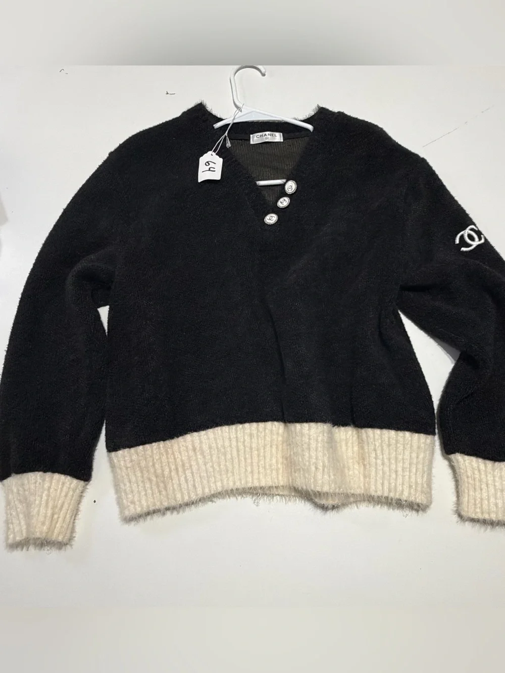 CHANEL Black V‑Neck Sweater with Cream Rib Hem